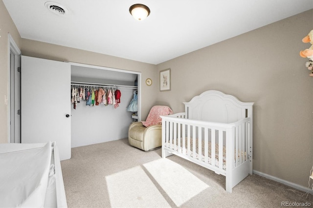 bedroom with carpet, a closet, and visible vents