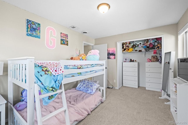 carpeted bedroom featuring visible vents