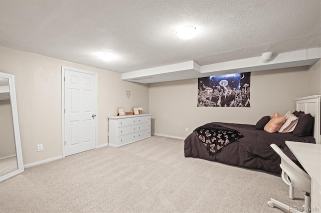 carpeted bedroom with a textured ceiling and baseboards