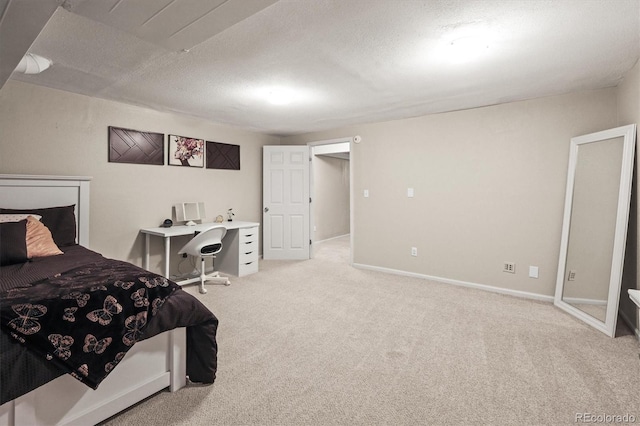 carpeted bedroom featuring baseboards and a textured ceiling