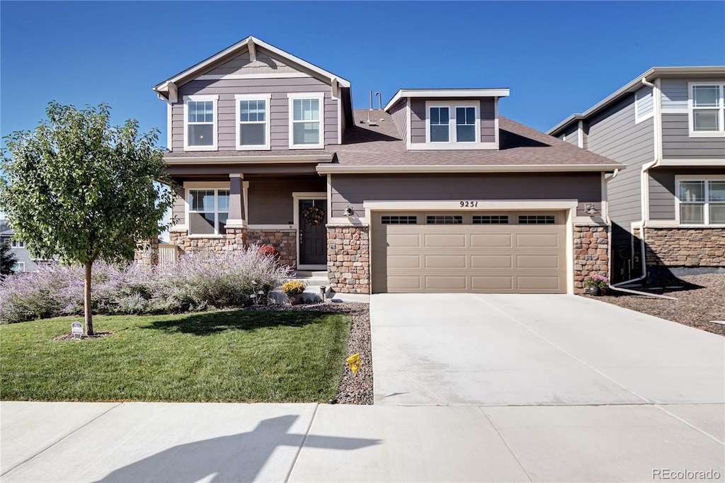 view of front of home with a garage and a front lawn