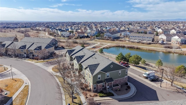 drone / aerial view featuring a residential view and a water view