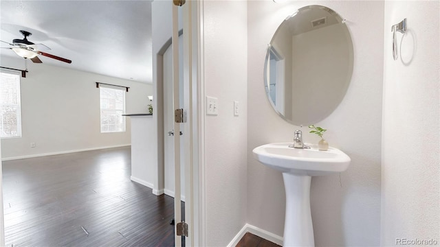 bathroom featuring ceiling fan, baseboards, and wood finished floors