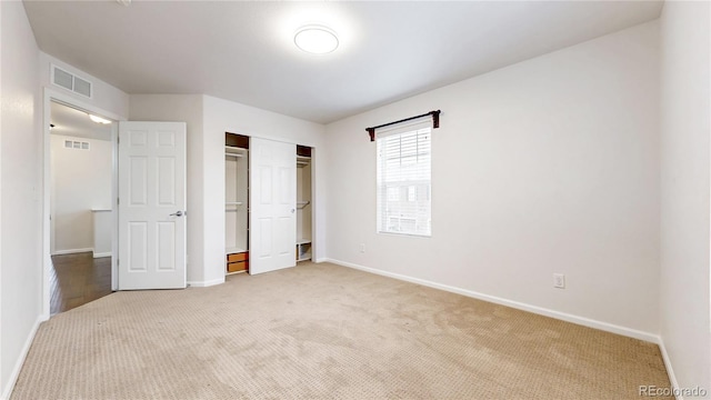 unfurnished bedroom featuring a closet, visible vents, baseboards, and carpet floors