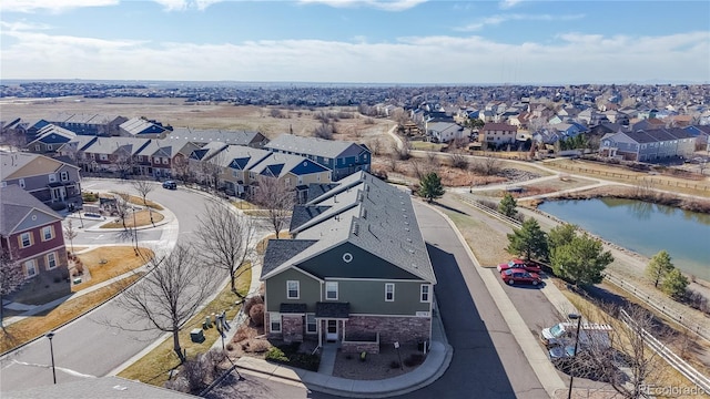 birds eye view of property with a residential view and a water view