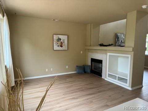 unfurnished living room with hardwood / wood-style flooring