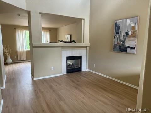 unfurnished living room featuring hardwood / wood-style flooring