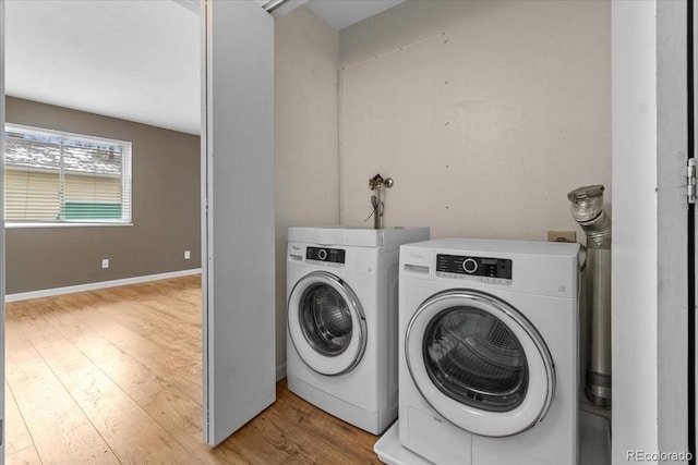 clothes washing area with laundry area, independent washer and dryer, and wood finished floors