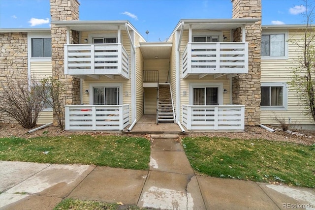 view of front of house with a chimney and a balcony