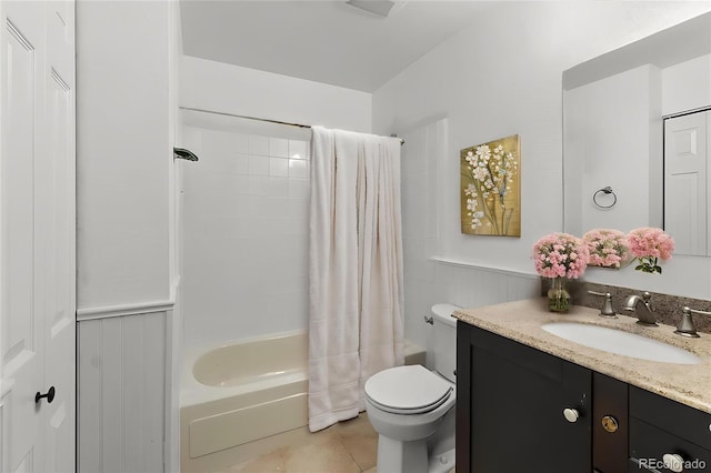 full bathroom featuring toilet, tile patterned floors, vanity, and shower / bath combo
