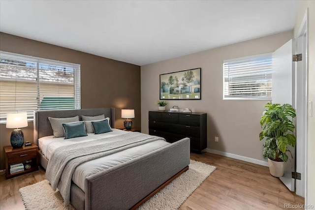 bedroom featuring baseboards and light wood-type flooring