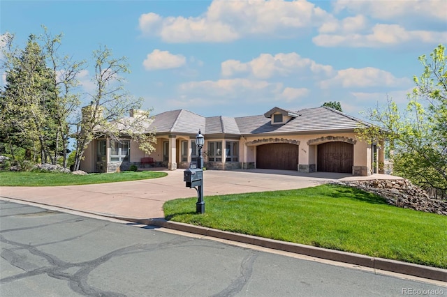 view of front of home featuring a front yard and a garage