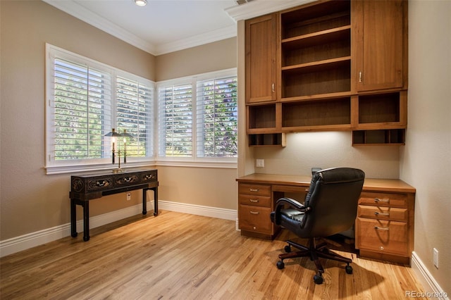 home office with ornamental molding and light hardwood / wood-style flooring