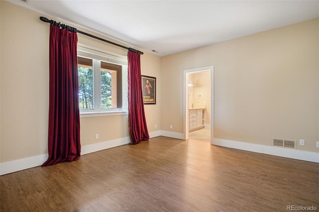 spare room featuring hardwood / wood-style floors