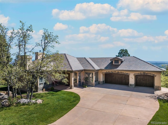 view of front facade with a garage and a front lawn