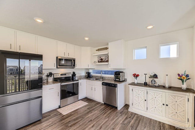18270 E 51st Pl, Denver, CO 80249 - kitchen featuring stainless steel appliances, open shelves, white cabinetry, a sink, and dark wood-type flooring