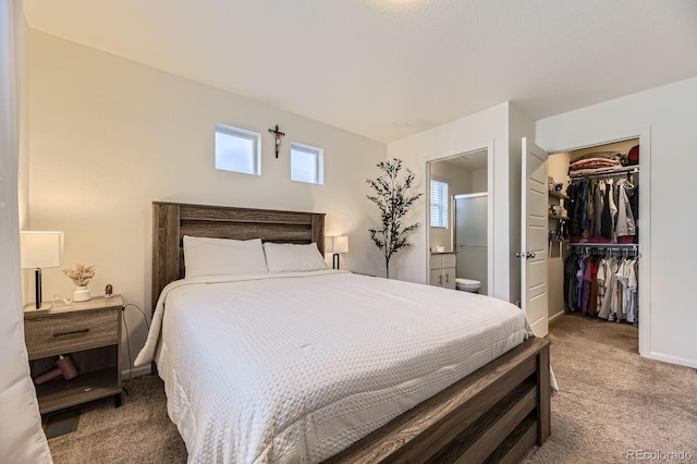 18270 E 51st Pl, Denver, CO 80249 - carpeted bedroom with ensuite bathroom, a closet, a walk in closet, and baseboards