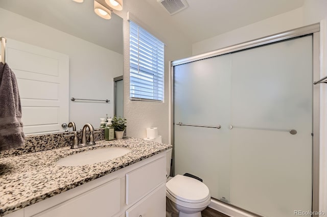 18270 E 51st Pl, Denver, CO 80249 - bathroom with vanity, toilet, and a shower stall