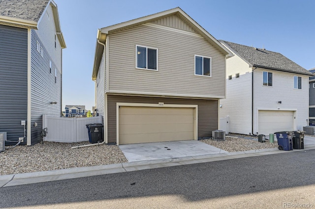 18270 E 51st Pl, Denver, CO 80249 - traditional-style house with an attached garage and central AC unit