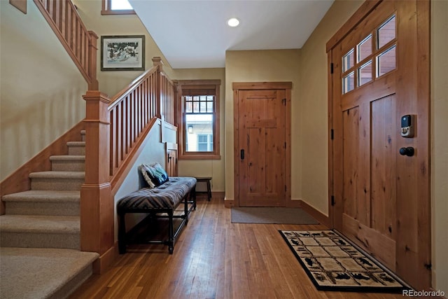 foyer entrance featuring recessed lighting, baseboards, stairway, and hardwood / wood-style floors