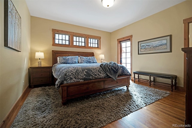 bedroom with baseboards and wood finished floors