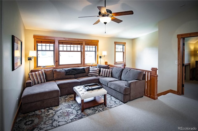 living room with carpet flooring, ceiling fan, and baseboards