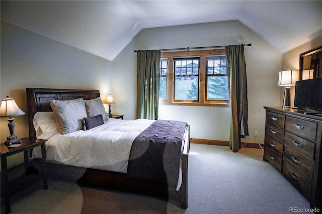 bedroom featuring lofted ceiling, light carpet, and baseboards