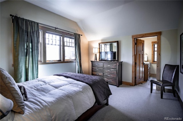 bedroom featuring lofted ceiling and light carpet