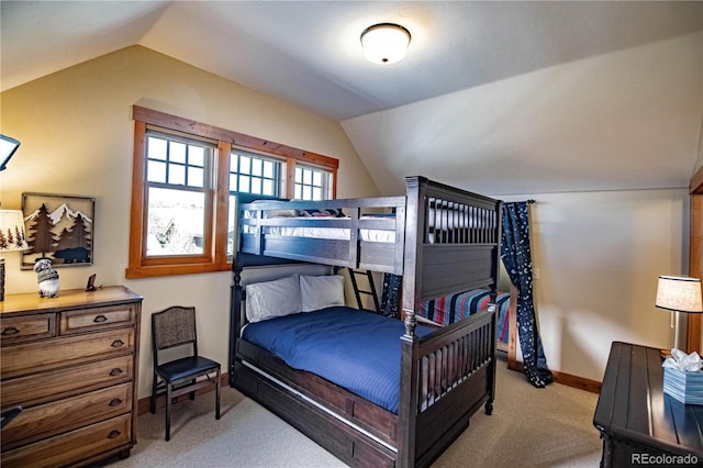 bedroom featuring lofted ceiling, baseboards, and light colored carpet