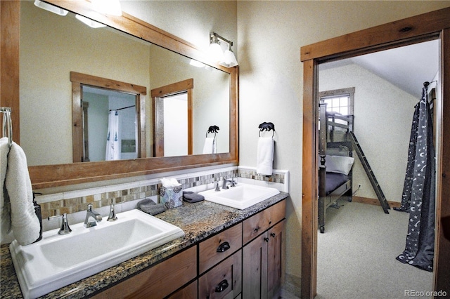 full bath featuring lofted ceiling, a sink, backsplash, and double vanity