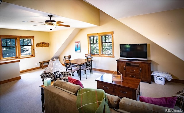 living area with carpet, ceiling fan, and baseboards