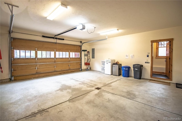 garage featuring electric panel and a garage door opener