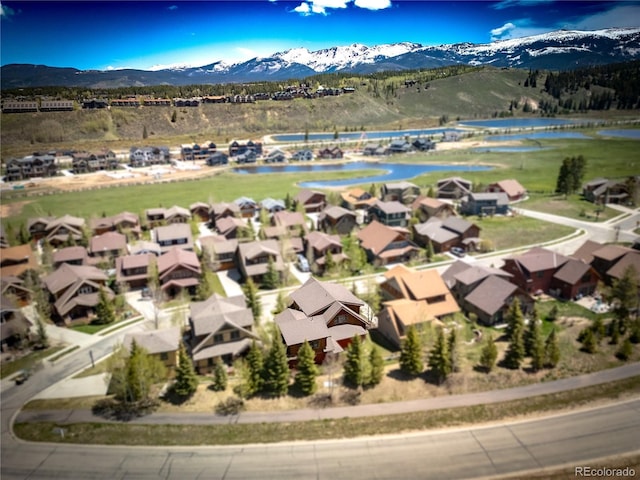 birds eye view of property with a residential view and a water and mountain view