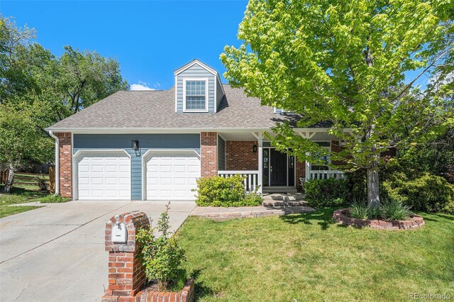 10247 W Roxbury Pl, Littleton, CO 80127 - view of front of house with driveway, an attached garage, a front lawn, roof with shingles, and brick siding