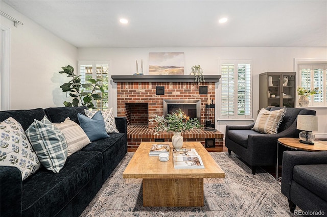 10247 W Roxbury Pl, Littleton, CO 80127 - living room featuring healthy amount of natural light, recessed lighting, and a brick fireplace