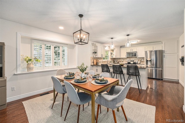10247 W Roxbury Pl, Littleton, CO 80127 - dining space featuring baseboards, a chandelier, dark wood-type flooring, and recessed lighting