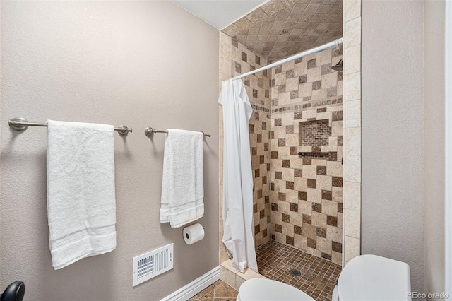 10247 W Roxbury Pl, Littleton, CO 80127 - full bathroom with toilet, a shower stall, tile patterned floors, and baseboards