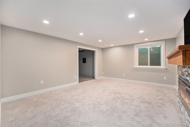 10247 W Roxbury Pl, Littleton, CO 80127 - unfurnished living room featuring a stone fireplace, light carpet, recessed lighting, and baseboards