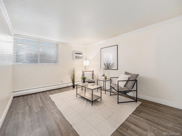 sitting room with ornamental molding, a baseboard heating unit, hardwood / wood-style floors, and a wall mounted air conditioner