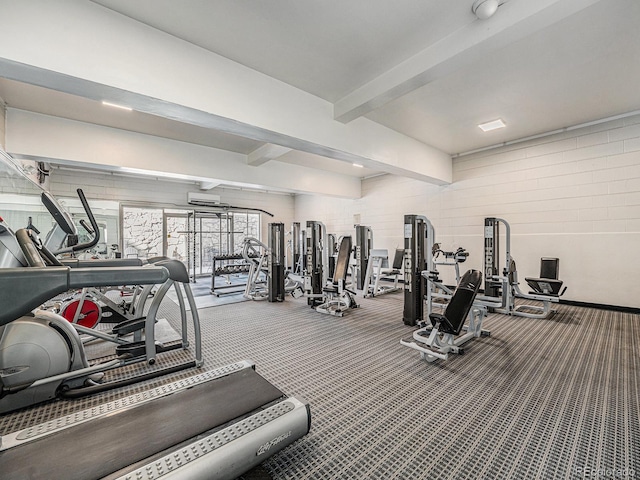 gym featuring a wall mounted air conditioner and carpet floors