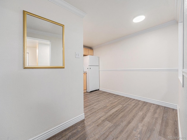 hallway featuring hardwood / wood-style flooring and ornamental molding