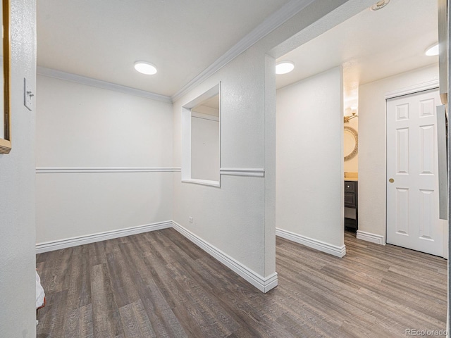 interior space with ornamental molding and dark hardwood / wood-style floors