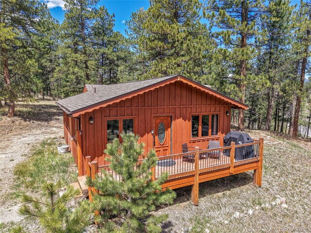 700 Rosalie Rd, Bailey, CO 80421 - view of front of home featuring board and batten siding, roof with shingles, and a wooden deck