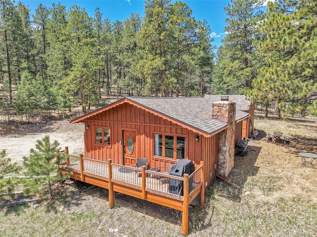 700 Rosalie Rd, Bailey, CO 80421 - rear view of property with board and batten siding, a shingled roof, a chimney, and a deck