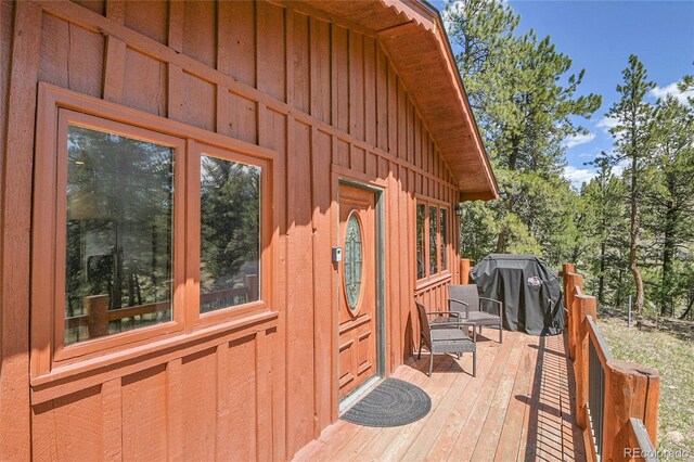 700 Rosalie Rd, Bailey, CO 80421 - property entrance with board and batten siding and a wooden deck