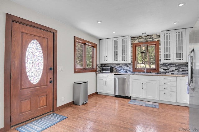 700 Rosalie Rd, Bailey, CO 80421 - kitchen with stainless steel appliances, decorative backsplash, a sink, baseboards, and light wood finished floors