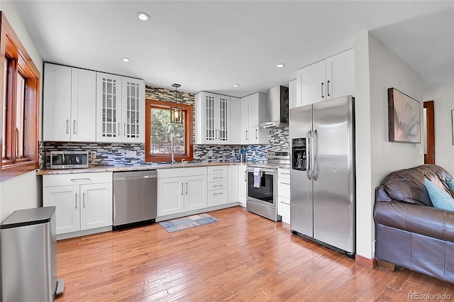 700 Rosalie Rd, Bailey, CO 80421 - kitchen with appliances with stainless steel finishes, wall chimney range hood, a sink, light wood-style floors, and recessed lighting