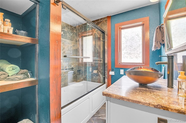 700 Rosalie Rd, Bailey, CO 80421 - full bathroom featuring vanity, shower / bath combination with glass door, and a textured wall