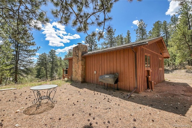 700 Rosalie Rd, Bailey, CO 80421 - view of home's exterior with board and batten siding and a chimney