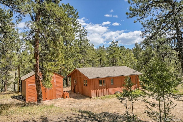 700 Rosalie Rd, Bailey, CO 80421 - back of house featuring a view of trees, roof with shingles, and board and batten siding